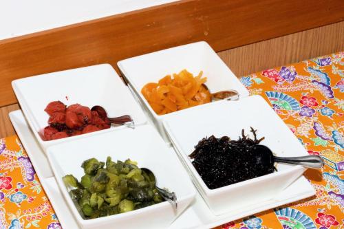 three white bowls of food on a table at Hotel Peace Island Miyakojima in Miyako Island