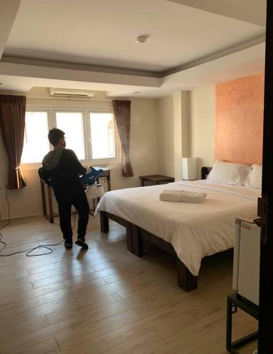 Postel nebo postele na pokoji v ubytování Arcadia Maephim Serviced Apartments