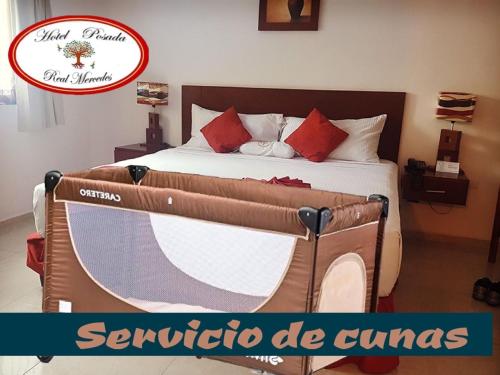 a large bed in a room with a sign that reads septoria de qu at Hotel Real Mercedes in Mérida