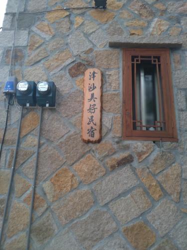 a stone building with a sign on the side of it at mei hao min su in Nangan