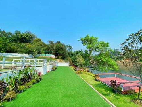 a view of the lawn from the balcony of a house at The Villa Sai yok noi in Khlong Luang