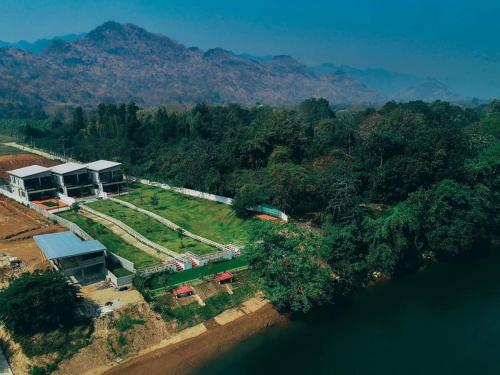 an aerial view of a house next to the water at The Villa Sai yok noi in Khlong Luang