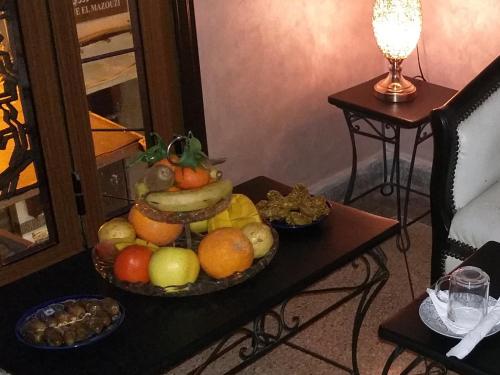 a bowl of fruit sitting on a table at Hotel LAHLOU riad Cafeteria in Oujda
