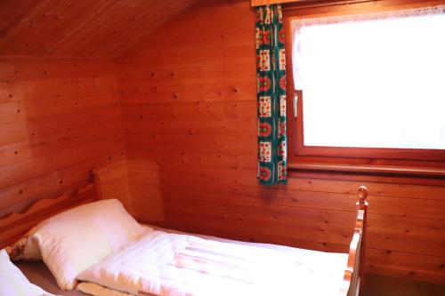 a bedroom with a bed in a log cabin at Landhaus mit Saunakeller in Bad Wünnenberg