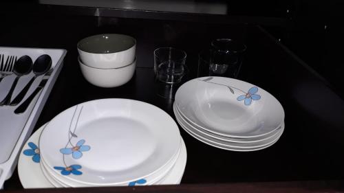 two white plates with flowers on them sitting on a table at Europa House Village in San Vicente del Raspeig