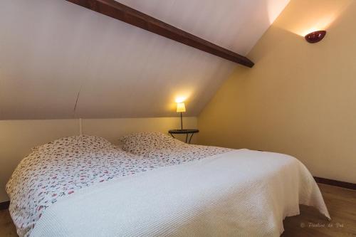 a bedroom with a white bed and a lamp at Domaine Leyvinie, gite Chardonnay, close to Dordogne in Perpezac-le-Blanc