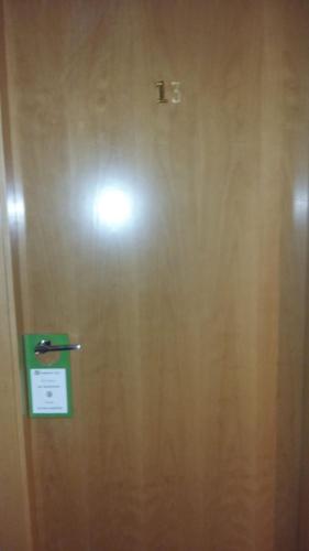 a wooden door with a sign on it at Europa House Village in San Vicente del Raspeig