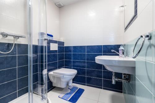 a bathroom with a toilet and a sink and a shower at Vinařství Výmola in Mikulčice