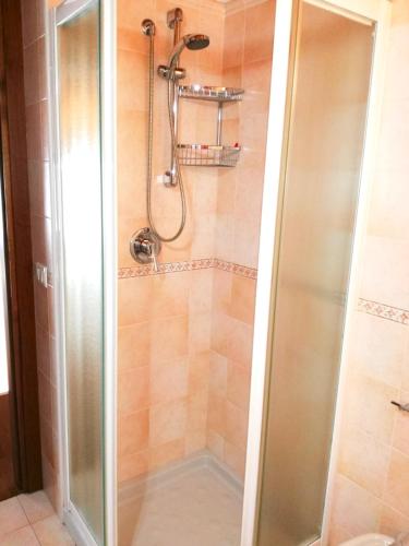 a shower with a glass door in a bathroom at Appartamento Orchidea Garda in Garda
