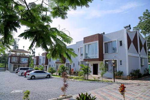 a row of houses with cars parked in a parking lot at Troy Lodge in Lusaka