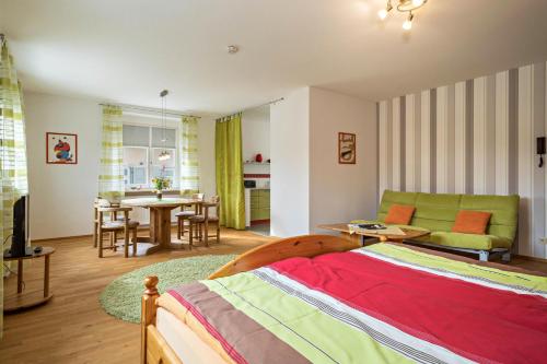 a bedroom with a bed and a living room at Ferienwohnung am Schloss in Heiligenberg