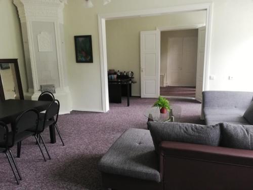 a living room with a couch and a table at Figaro in Ventspils