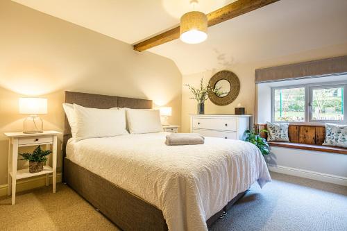 a bedroom with a large bed and a window at James Cottage in Chelmorton