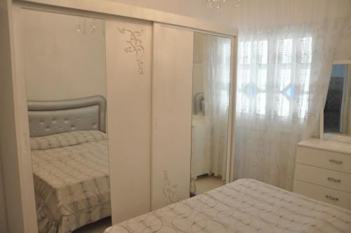 a bedroom with a bed and a dresser and a mirror at Dar El Fatimid sur le port de Mahdia free WIFI in Mahdia
