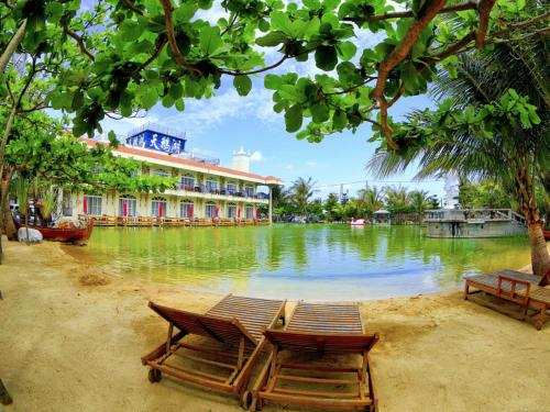 a resort with chairs and a body of water at Swan Lake Villa Resort in Nanwan