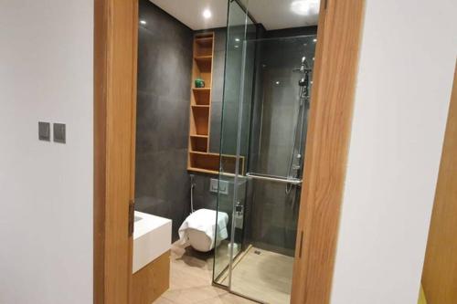 a bathroom with a glass shower and a sink at Metro Access Cozy Furnished Studio at JBR walk in Dubai
