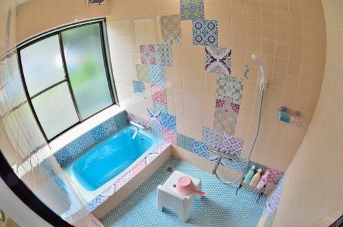 a toy bathroom with a tub and a shower at Breathtaking View House in Ito