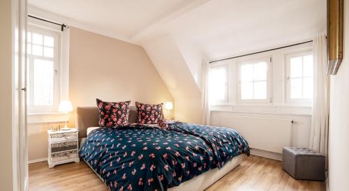 a bedroom with a bed and two windows at Ferienwohnung Julia in Suhl