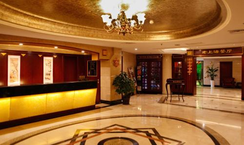 a lobby of a hotel with a chandelier at Seventh Heaven Hotel in Shanghai