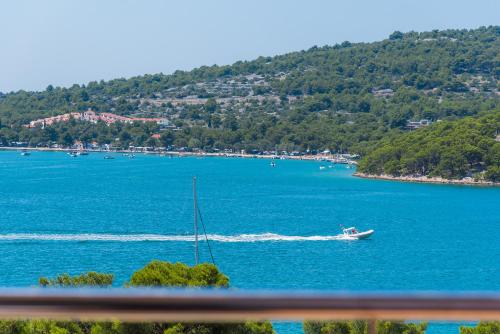a boat in a large body of water at Apartments Hari Tisno in Tisno