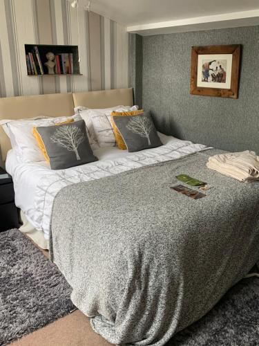 a bedroom with a large bed with two pillows at The Granary Country Retreat in Lampeter