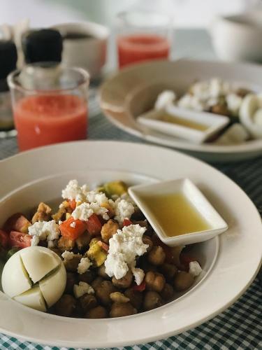 a plate of food with a bowl of beans and cheese at Badolina Bungalows in Nungwi