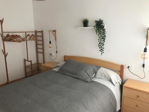 a bedroom with a bed and a plant on the wall at peñiscola playa primera linea ,parquing incluido in Peñíscola