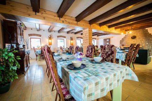 a dining room with a table and some chairs at Mlyn Tatry in Veľký Slavkov