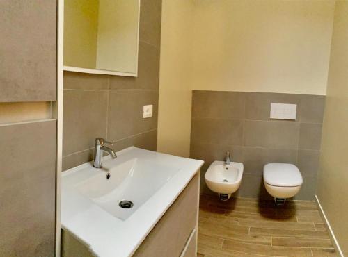 a bathroom with a sink and a toilet at Savenella Apartments in Bologna
