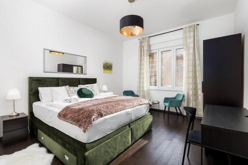 a bedroom with a bed and a table and chairs at Apartman Altamar Rijeka in Rijeka