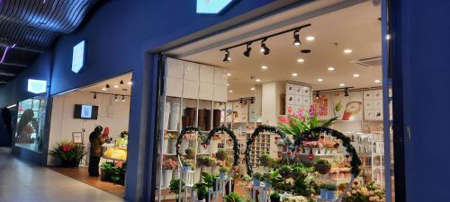 a store front of a flower shop with flowers at Arena SOHO Kuching with infinity rooftop pool and free WiFi in Kuching