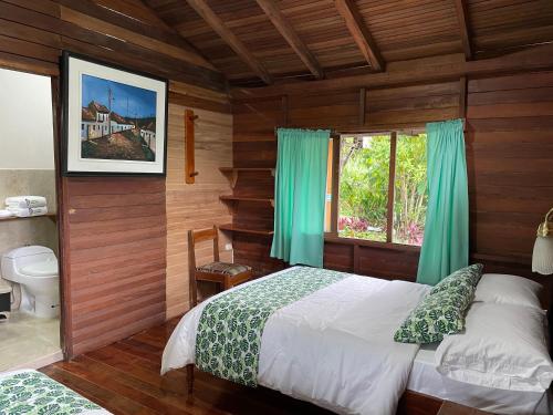 a bedroom with a bed and a window at Cabañas Germany in Puyo