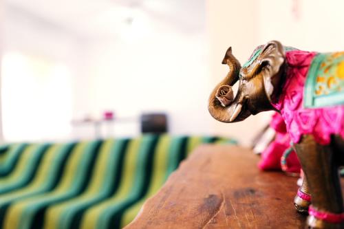 a figurine of a toy cow sitting on a table at SIGRUM Hostel in San Rafael