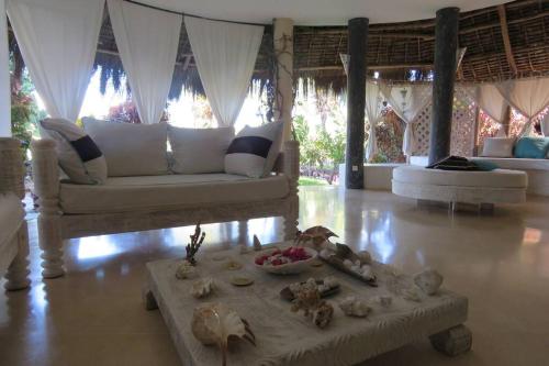 a living room with a couch and a table at Fortamu - Tembo House in Watamu