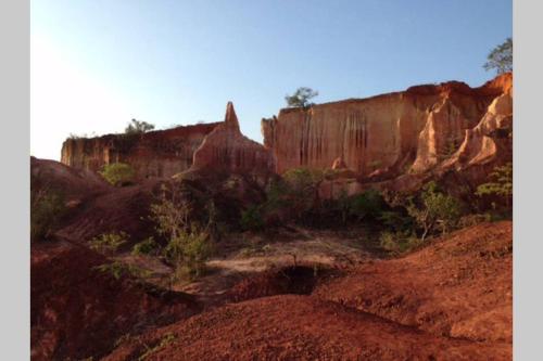 a view of a canyon with red dirt and rocks at Fortamu - Tembo House in Watamu