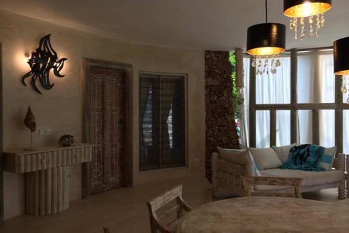 a living room with a couch and a table at Fortamu - Tembo House in Watamu