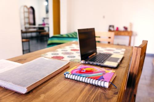 a laptop computer sitting on top of a wooden table at SIGRUM Hostel in San Rafael