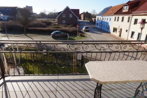 a balcony with a bench and a view of a street at Altstadt-Insel in Rathenow