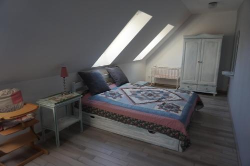a bedroom with a bed with a dresser and a night stand at Altstadt-Insel in Rathenow