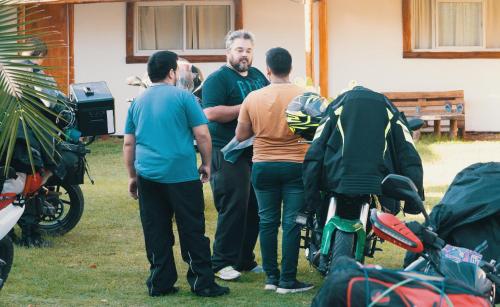 a group of men standing next to a motorcycle at SIGRUM Hostel in San Rafael