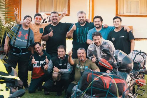 a group of men posing for a picture with motorcycles at SIGRUM Hostel in San Rafael