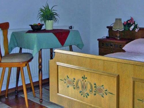 a bedroom with a bed and a table and a table and chair at Pension Seeblick in Attersee am Attersee