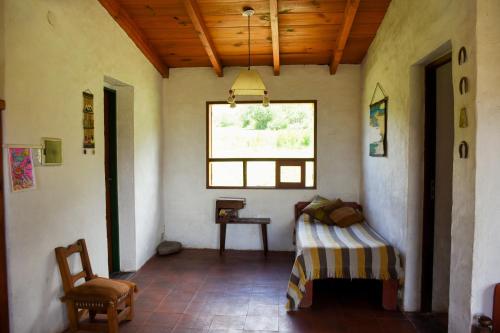 a room with a bed and a window at Casa en Tafí del Valle in Tafí del Valle