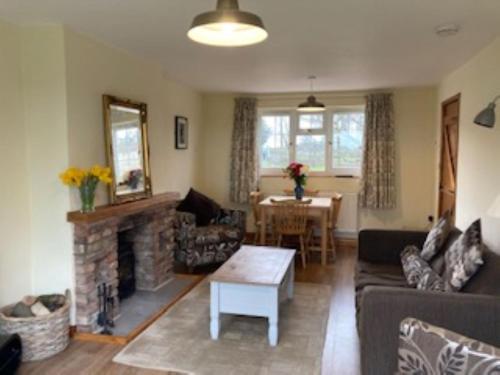 a living room with a couch and a fireplace at Signal Cottage at The Red House Estate in York