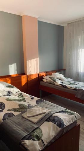 two beds in a room with at Bianco - pokoje noclegowe in Częstochowa