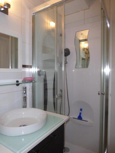 a bathroom with a glass shower and a sink at à la montagne en famille App106 in Cauterets