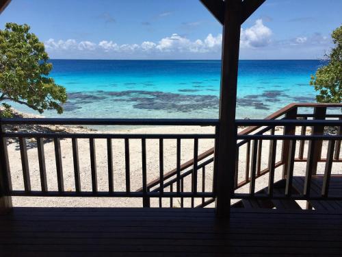 a view from a balcony of a beach with a view of the ocean at Fafapiti Lodge Fakarava in Fakarava