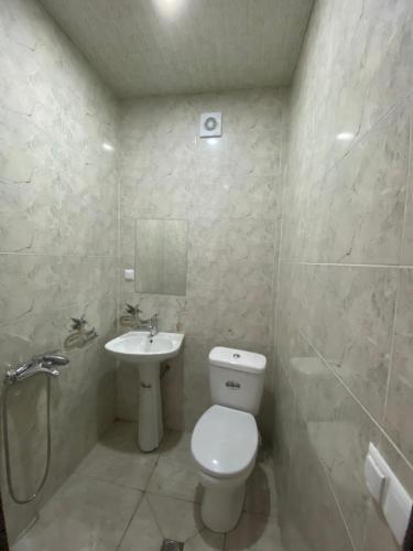 a bathroom with a toilet and a sink at Guest House Sunrise in Khulo