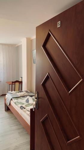 a door leading to a bedroom with a bed at Bianco - pokoje noclegowe in Częstochowa