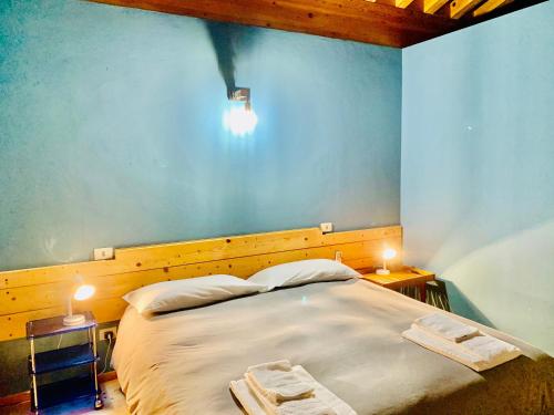 a bedroom with a large bed with two night stands at Casale Artemisia Capalbio in Capalbio